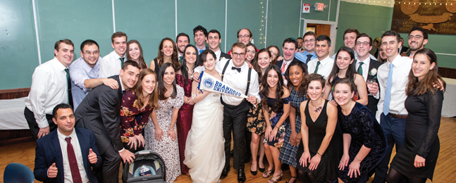 A crowd of guests surround Herbie Rosen and his bride at their wedding